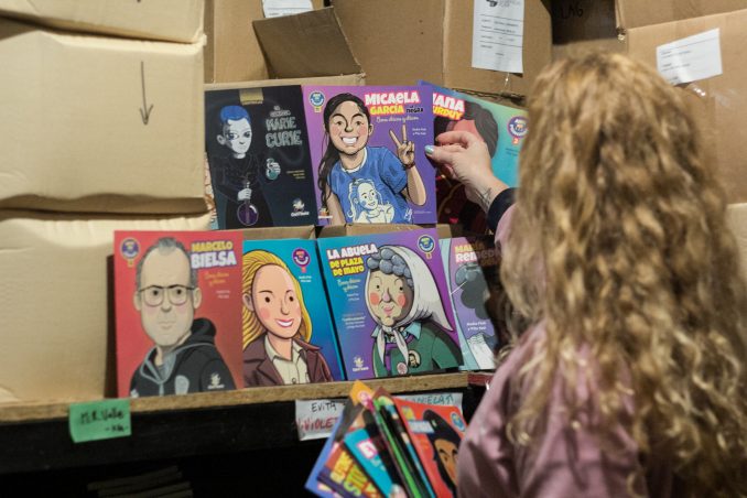 La autora Nadia Fink de la editorial Chirimbote agarrando algunos de sus libros para infancias.